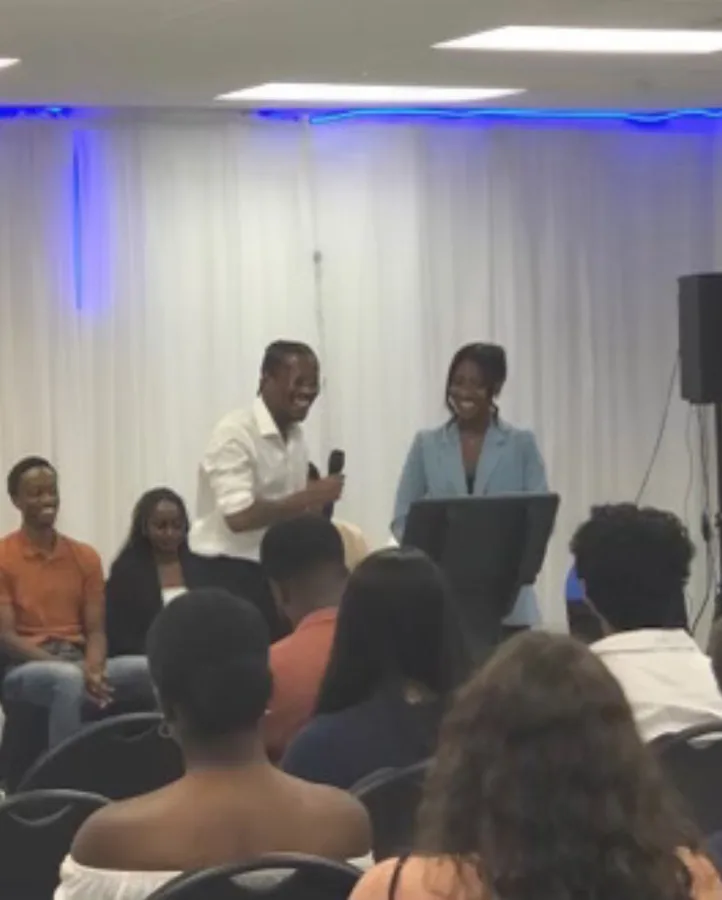 A panel discussion in front of a full room