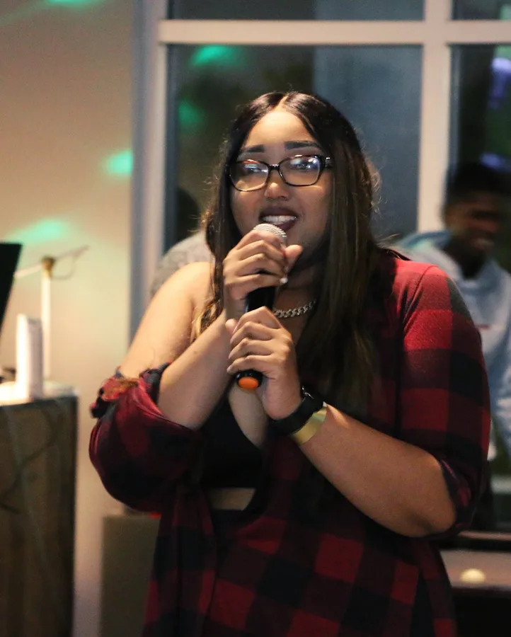 A singer performing for the room